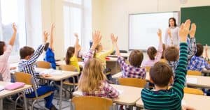 school children learning with teacher